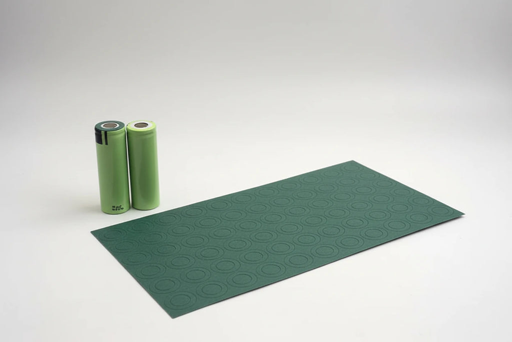 Green battery insulation ring with two batteries on a white background