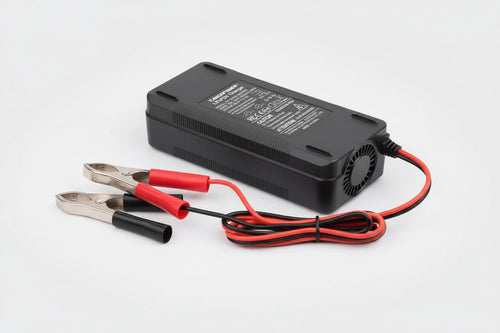 Black battery charger with red and black cables on a white background