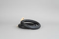 Two black inner tubes on a concrete surface with a brick wall in the background